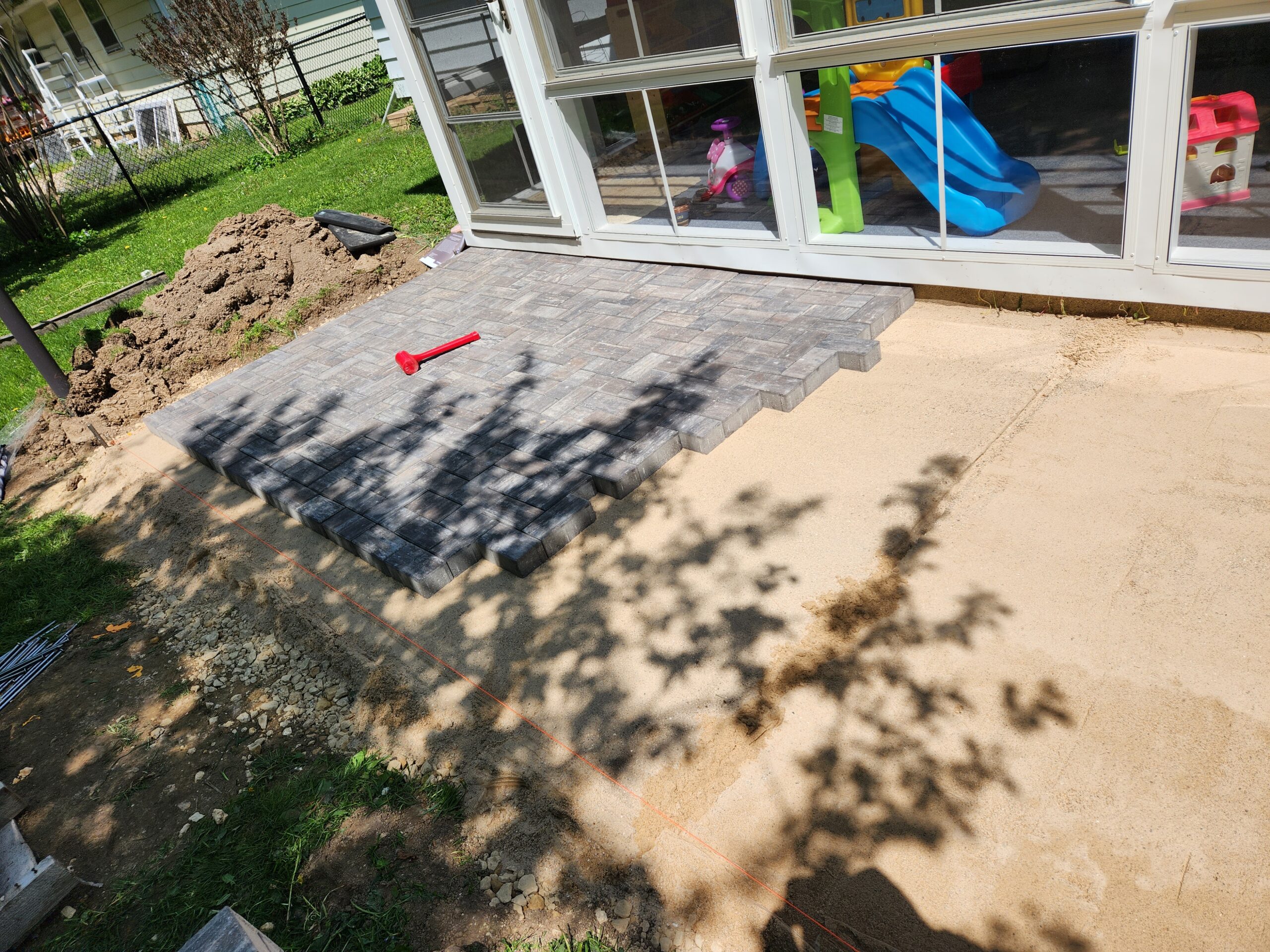 Small backyard patio in the process of being built by Oakhaven Contractors.