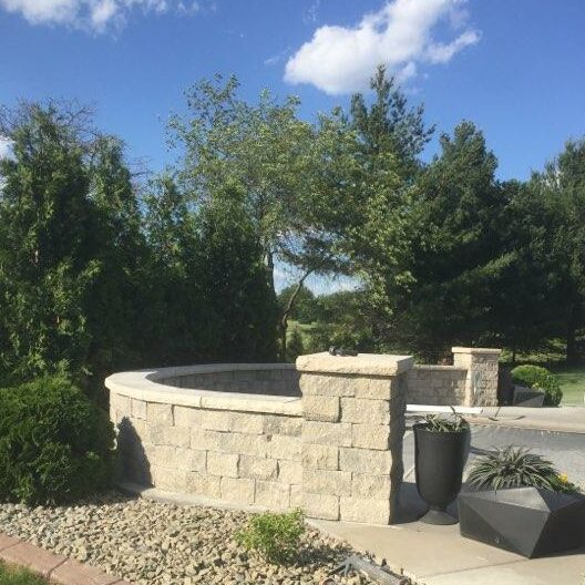 Semi circle paver retaining wall constructed by a member of the Oakhaven Contractor team.